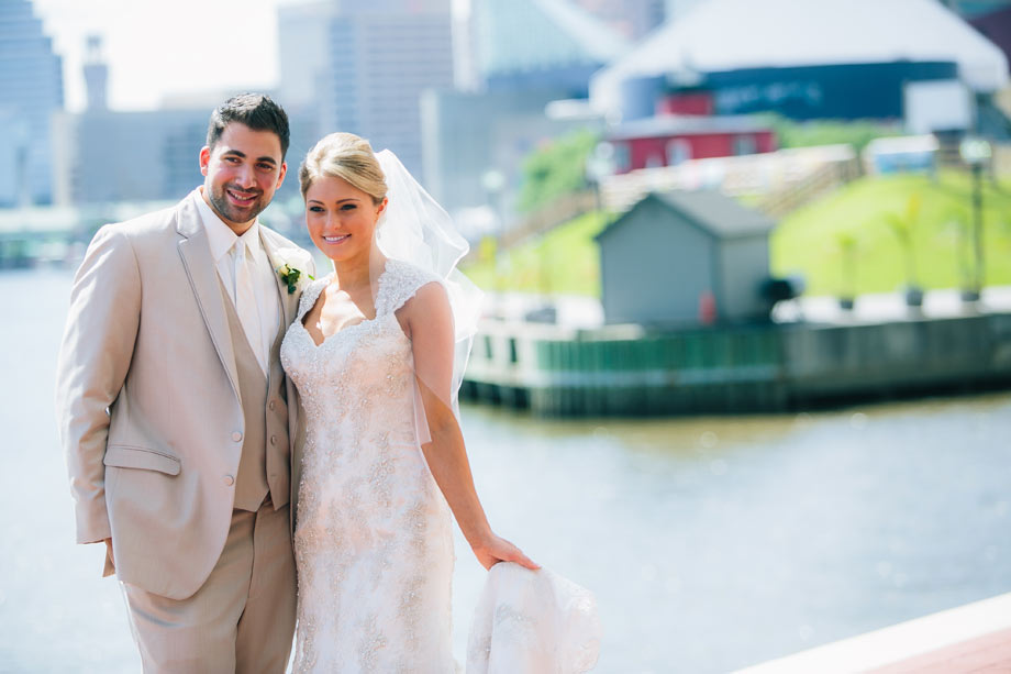 bride and groom posing at baltimore inner harbor