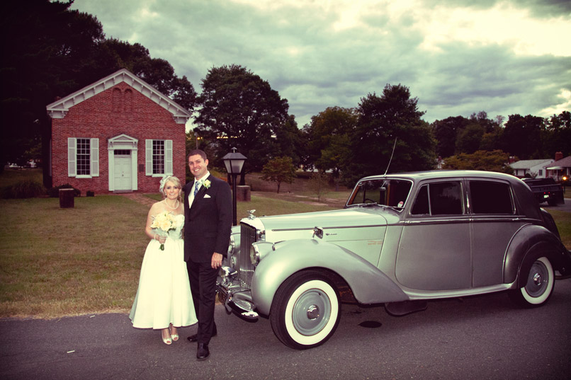 Bride and groom with classic car limo