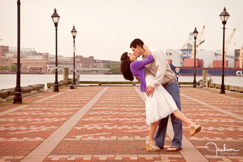 Groom kissing bride on Fells Point Pier