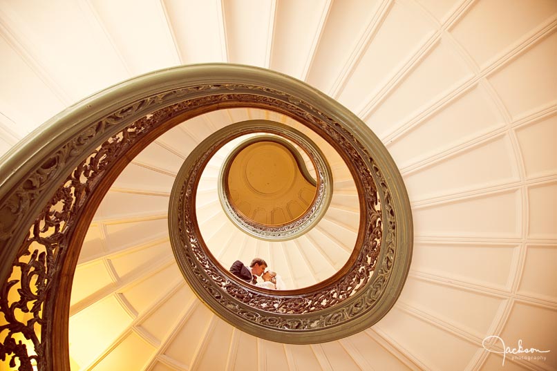bride and groom on peabody's spiral staircase