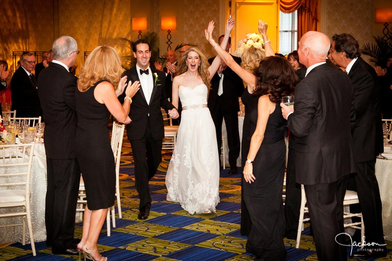 bride and groom entering the reception