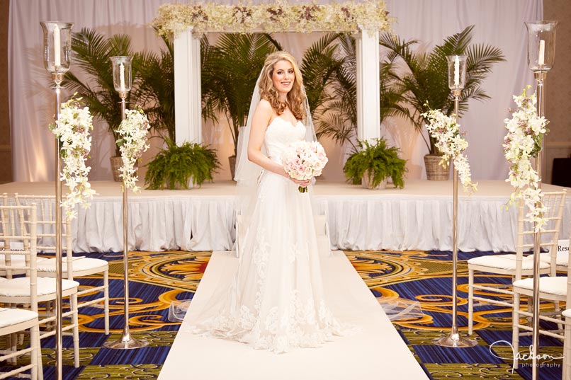 bride posing in front of the chuppah