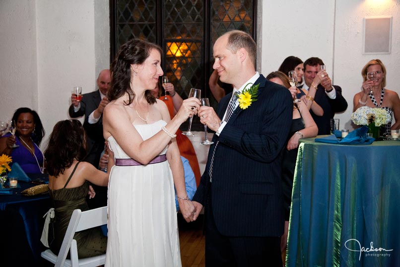 bride and groom clinking their glasses