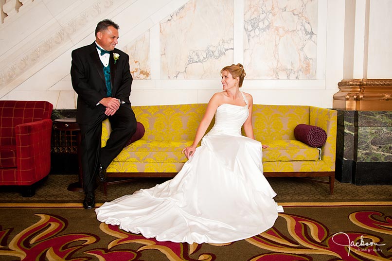 bride and groom on antique yellow couch