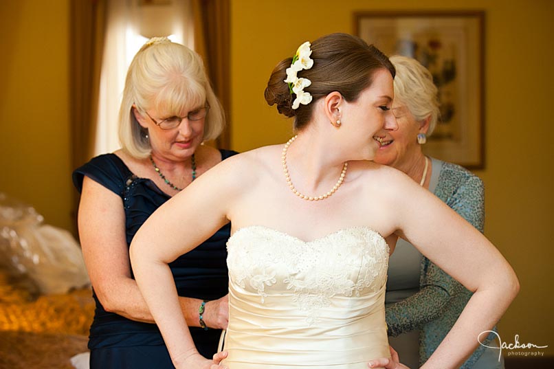 mother lacing up bride's dress