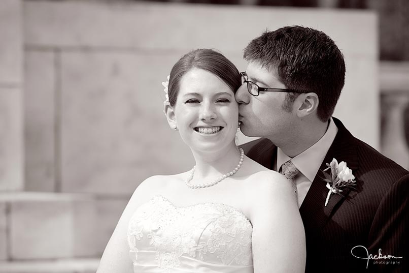 groom kissing bride black and white