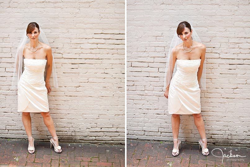 Bride posing against white brick wall