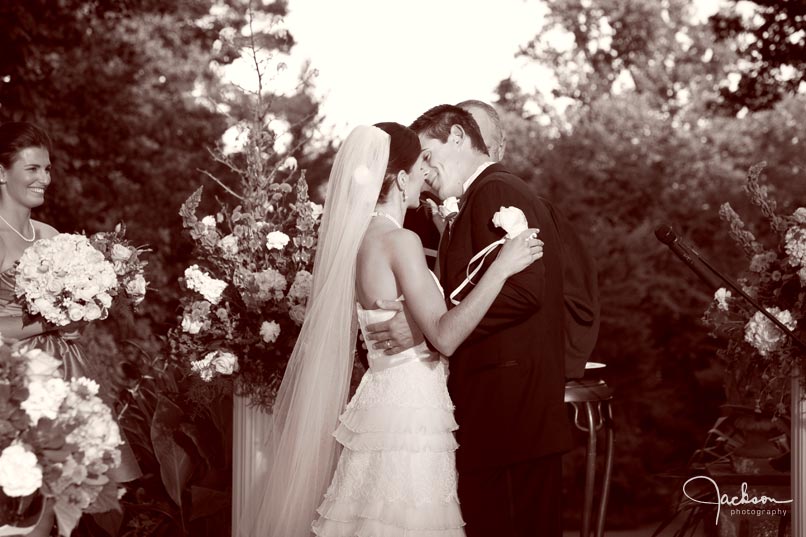 bride kissing groom at ceremony