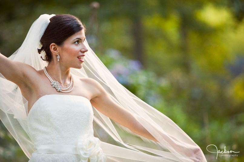 bride stretching veil in the wind