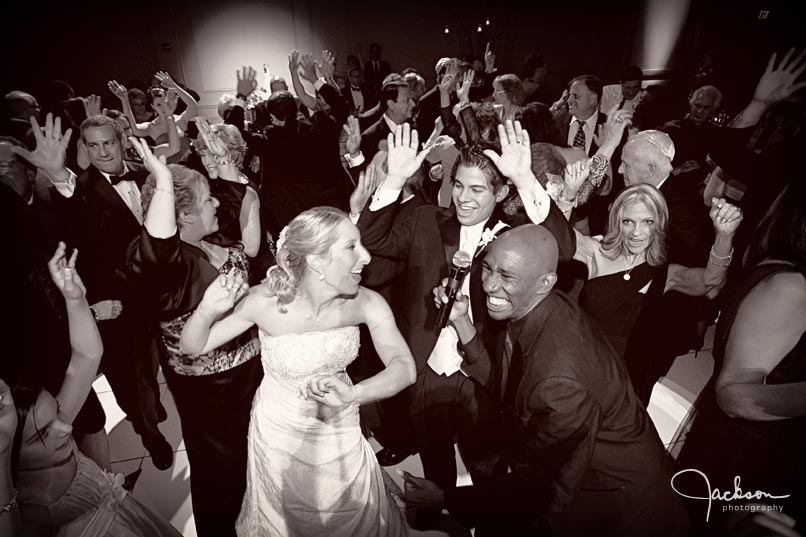 bride and groom dancing with band