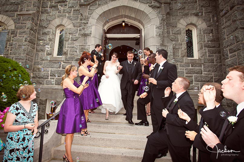 bride and groom showered by bubbles