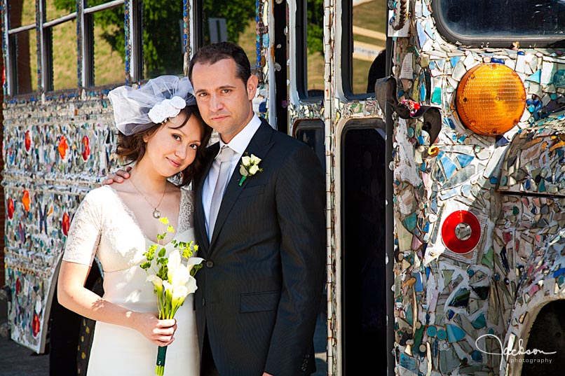 bride and groom in front of visionary bus