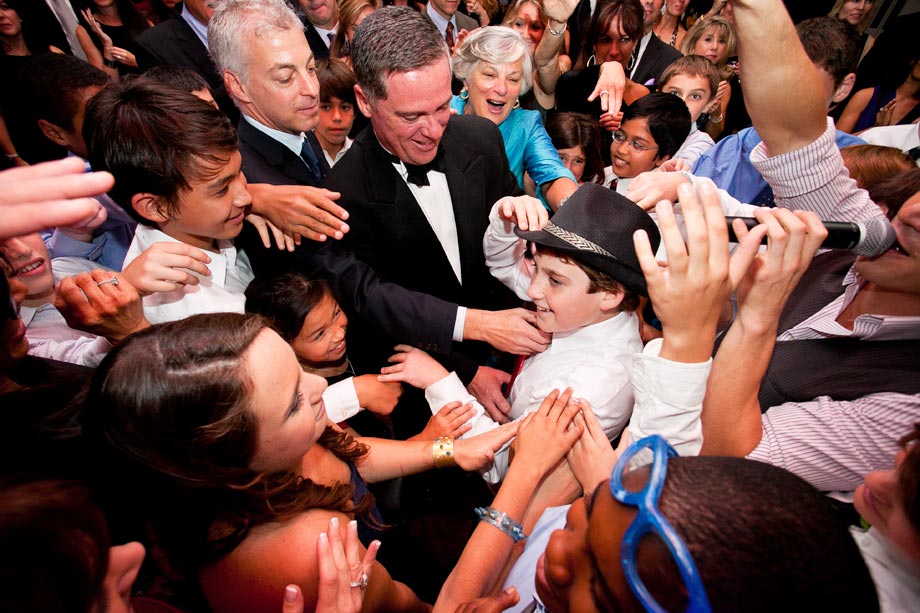 everyone dancing and touching mitzvah boy