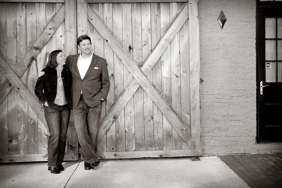 couple posing in front of large door