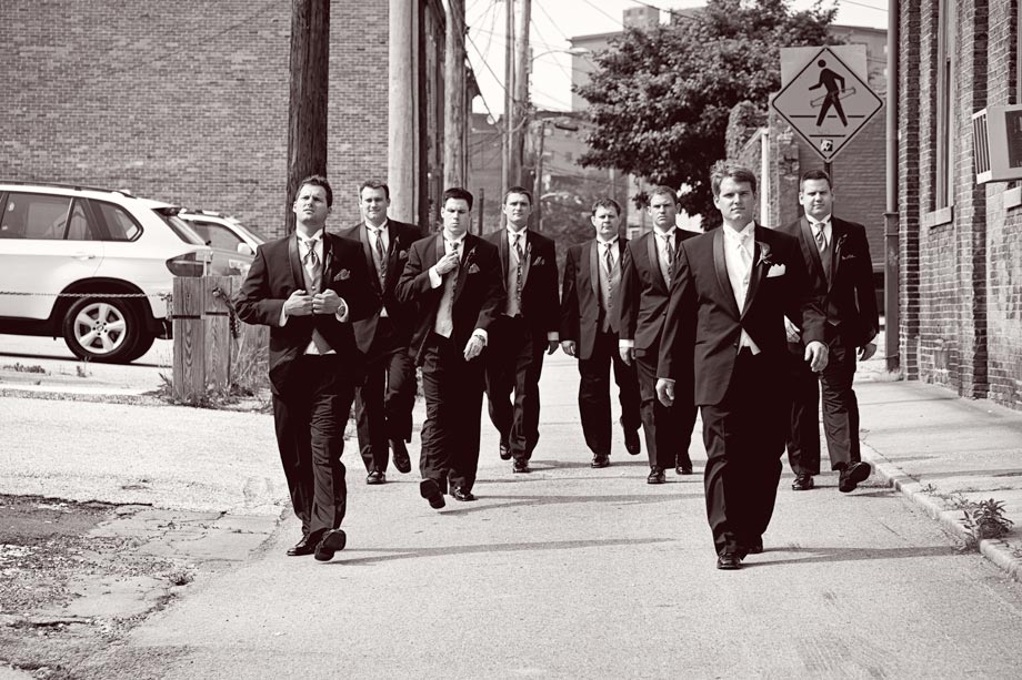 groomsmen walking down alleyway