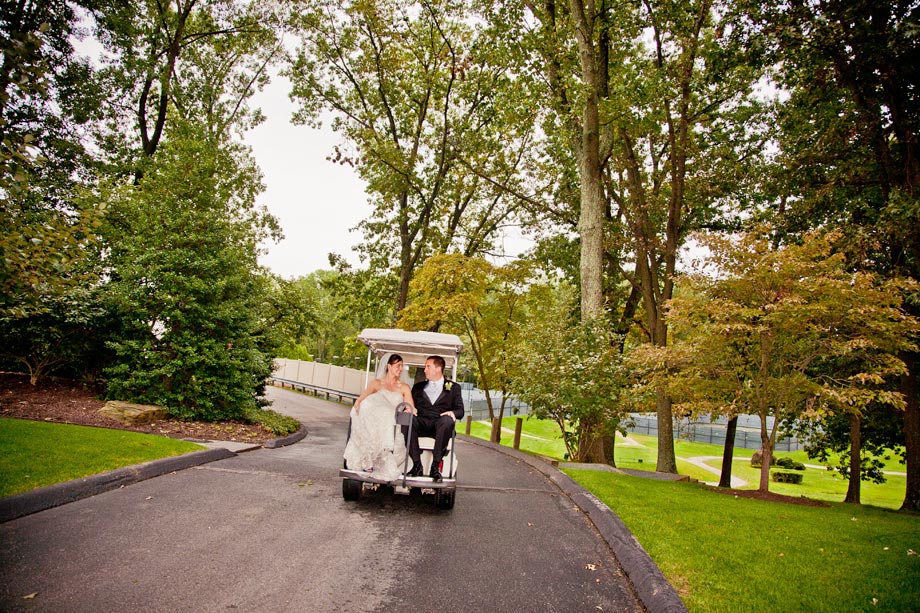 bride and groom in golf cart