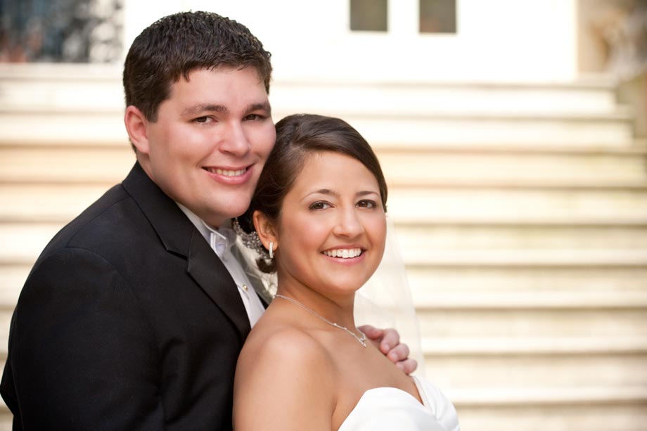 bride and groom in front of evergreen