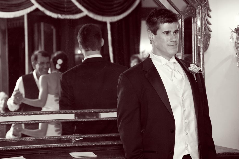 groom watching father daughter dance