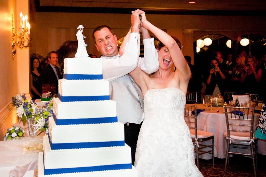 bride and groom cutting cake with axe