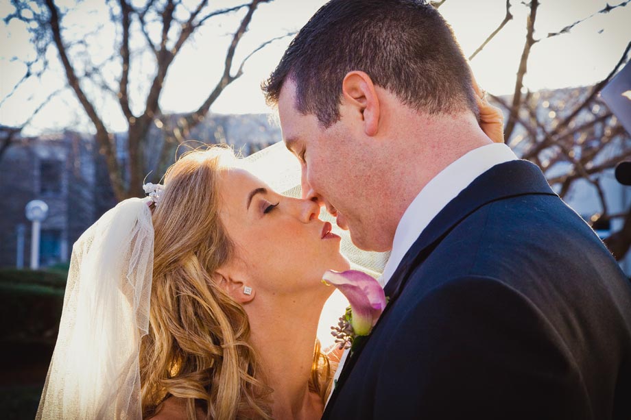 bride and groom kissing close up