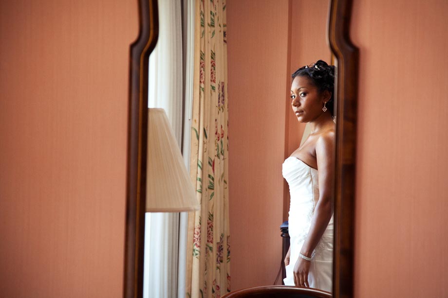 african american bride looking in mirror