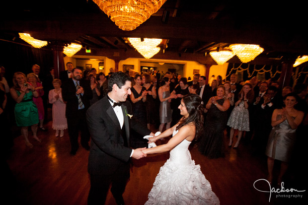 bride and groom dancing among friends