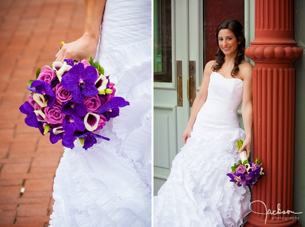 bride posing on column with purple flowers