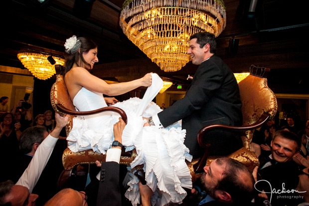 bride and groom in chairs hora