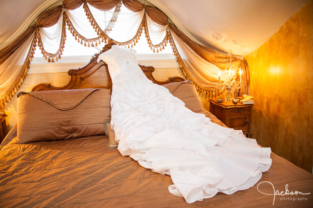 bride's dress laying on bed