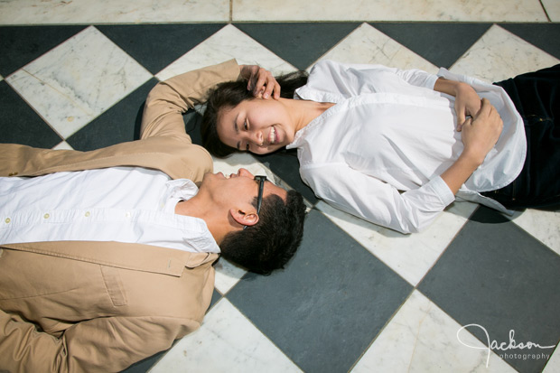 couple lying on checkered tile floor