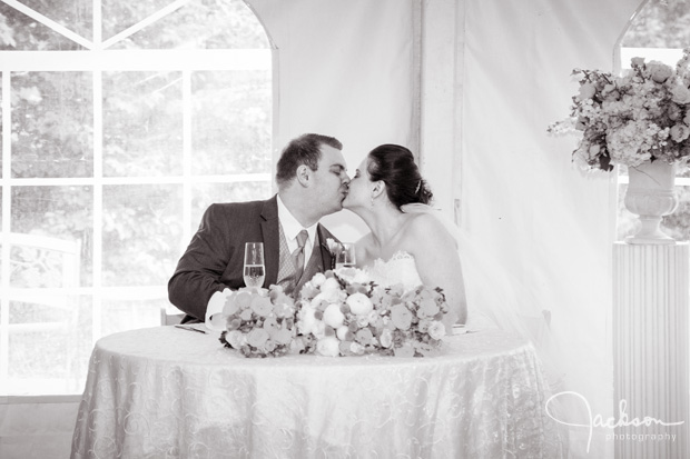 bride and groom kissing at toast