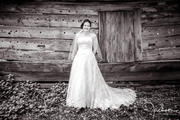 bride in front of rustic shed