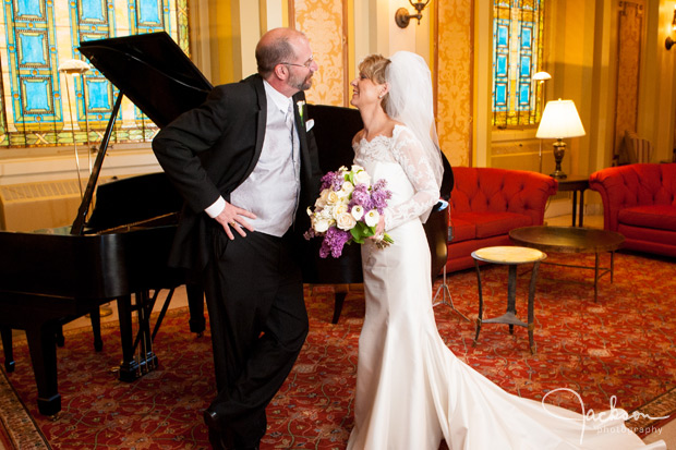 bride and groom by piano