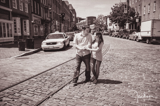 couple walking on cobblestone street