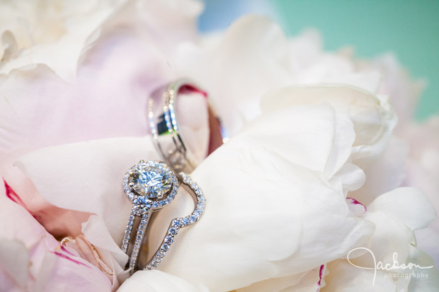 white and pink bouquet with wedding rings