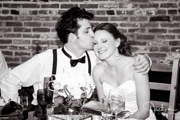 groom kissing bride on side of head