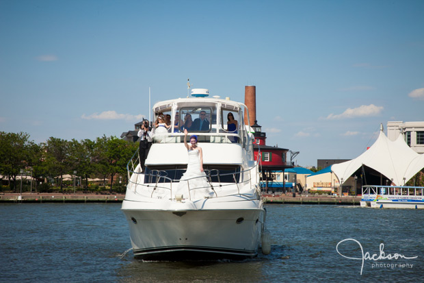 bride waving to groom from boat