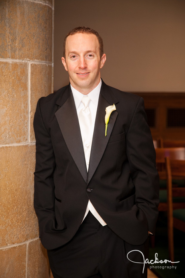 groom leaning on column of loyola