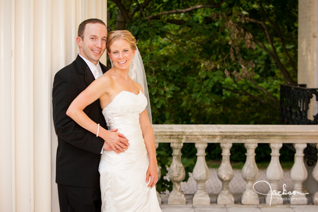 bride and groom on steps of evergreen house