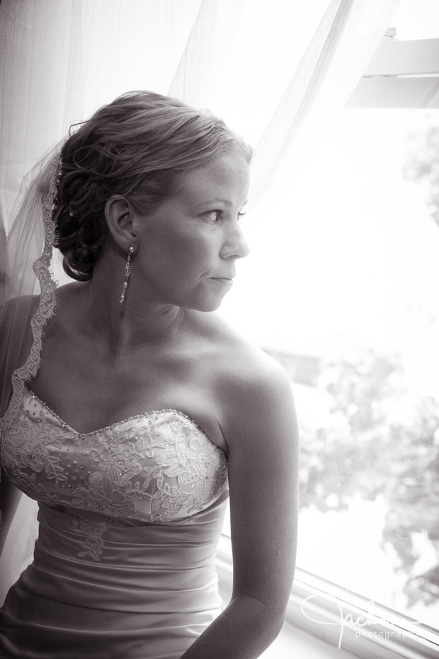 bride by house window