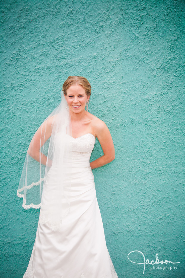 bride on aqua stucco wall