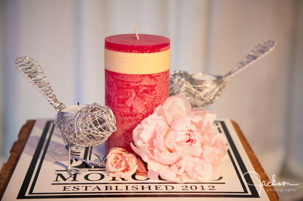 wire birds candle and pink rose at altar