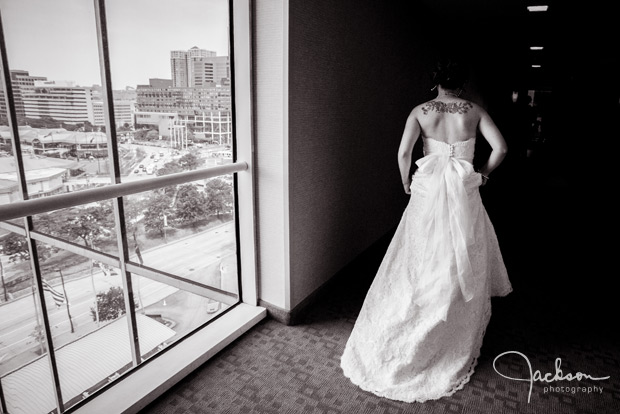 bride walking down hotel hallway with window light