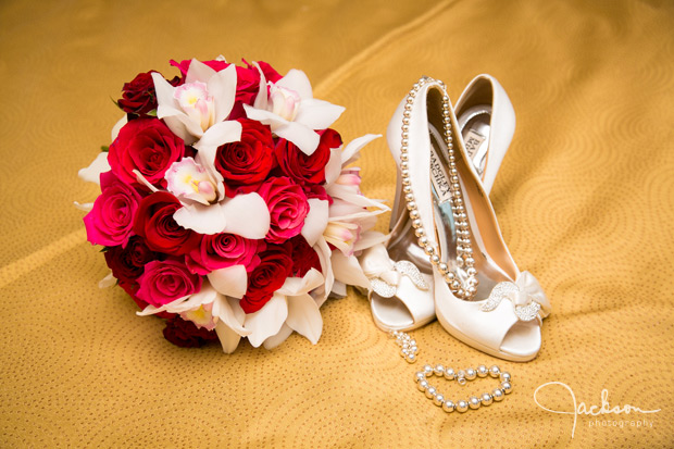 red and white orchid bouquet with pearls and shoes