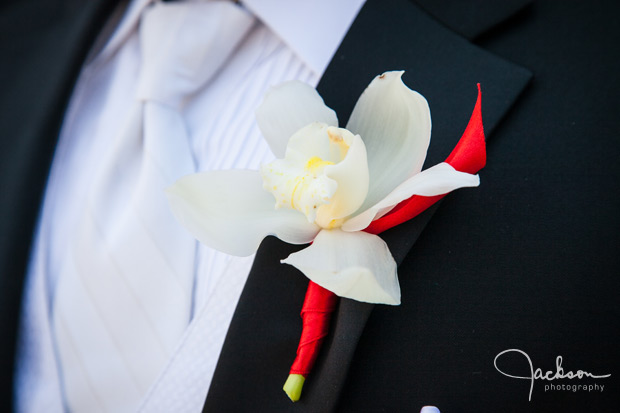 white and red orchid boutonniere 
