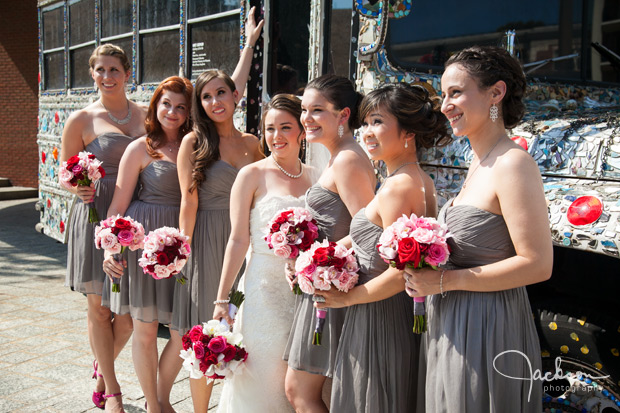 bridesmaids with grey dresses red and white bouquets