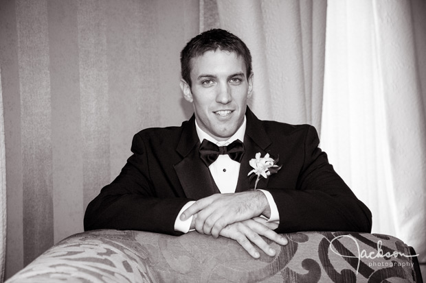 groom leaning over art deco chair