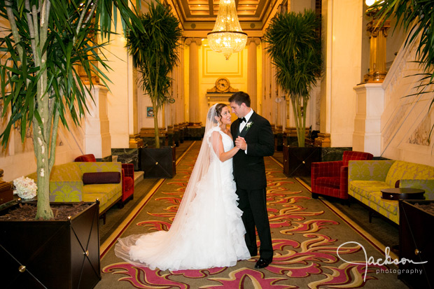 bride and groom in grand lobby of hotel monaco