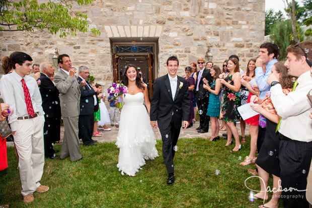 bride and groom leaving church with bubbles