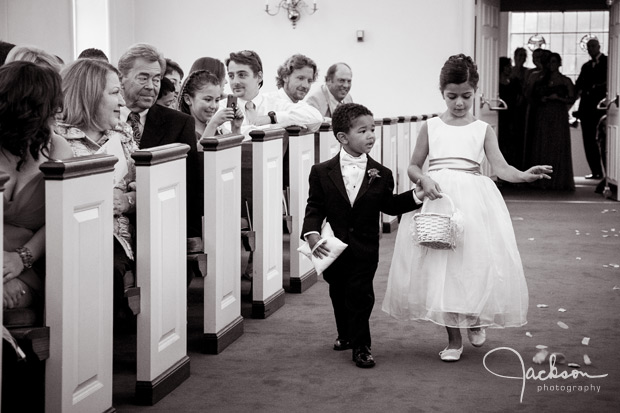 ring bearer and flower girl walking down the aisle